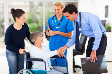 friendly medical doctor greeting senior patient