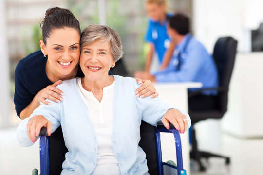 Adult Daughter Accompanying Senior Mother Visiting Doctor