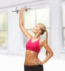 woman lifting steel dumbbell