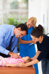 medical doctor examining baby