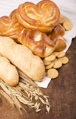 ears of cereals and rich bread on a wooden table