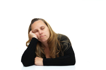 A tired woman sleeping on the desk