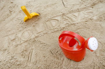 Fototapeta na wymiar Wor holidays in sand with beach toys