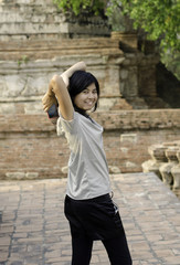 Fototapeta na wymiar Asian woman at Wat Maheyong Temple. Ayutthaya - Thailand