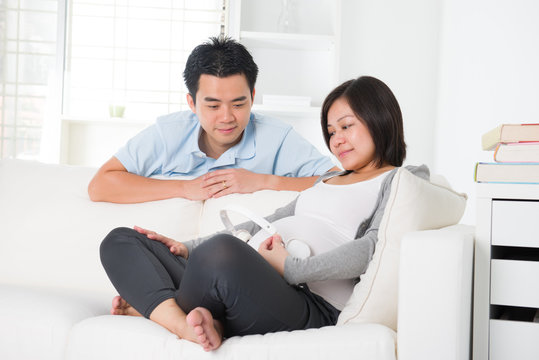 asian chinese pregnant couple lifestyle photo with living room a