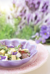 Obraz na płótnie Canvas Salad with feta cheese, avocado and violets