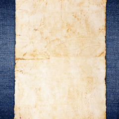 Vintage paper on blue jeans background