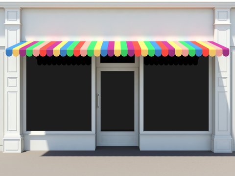 Shopfront in the sun - classic store front with colored awnings