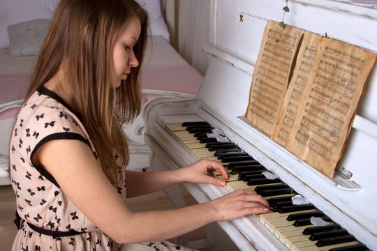 young woman playing the piano