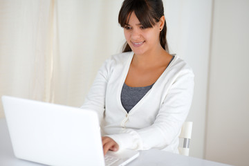 Pretty young woman working on laptop computer