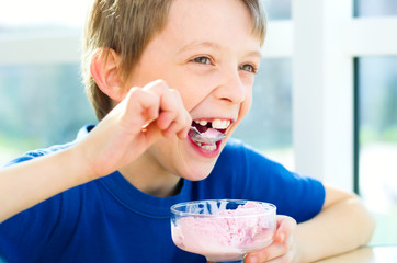 Young boy eating a tasty ice cream