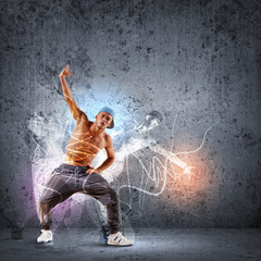 Obraz na płótnie Canvas young man dancing hip hop with color lines