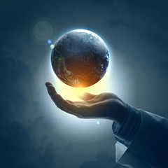 Image of earth planet on hand