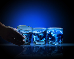 Three glasses of blue liquid
