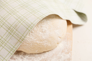 Dough on wooden board