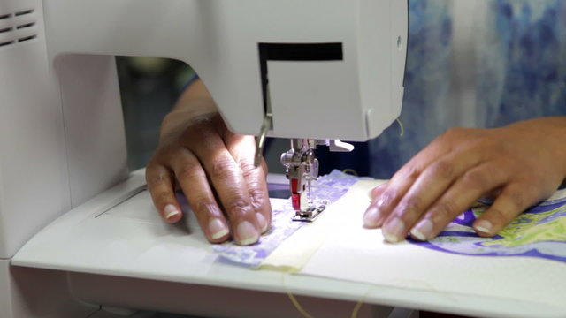Close Up Of Woman Sewing Using Electric Machine