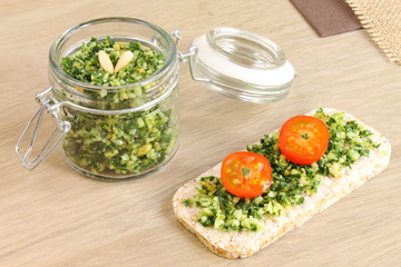 Slice of toast with pesto sauce and tomato