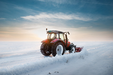 Tractor cleaning snow
