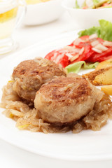 Meatballs with stewed onion and fried potato wedges