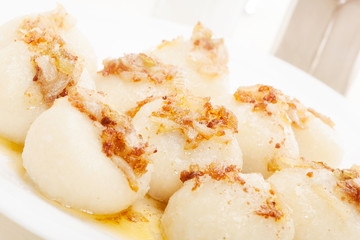 Meat stuffed dumplings with fried onion