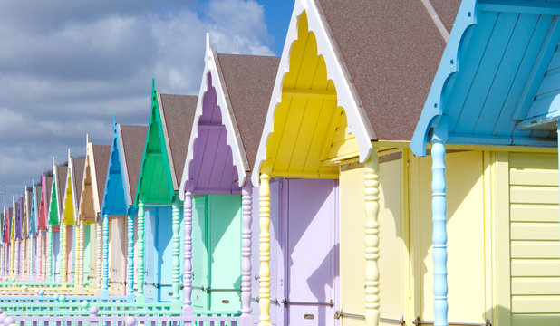 Traditional British beach huts on a bright sunny day