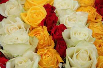 yellow, white and red roses in a wedding arrangement