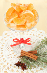 Obraz na płótnie Canvas Tasty mandarine's slices in glass bowl on light background