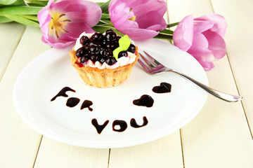 Sweet cake with blackberry and chocolate sauce