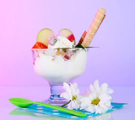 Ice cream with wafer sticks on napkin on color background