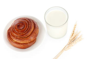 Bread roll and glass of milk isolated on white
