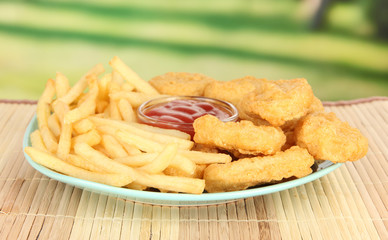 Fried chicken nuggets with french fries and sauce