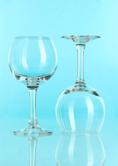 Two glasses on light blue background