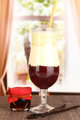 Delicious fruit smoothie on window background