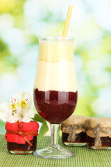 Delicious fruit smoothie on bright background