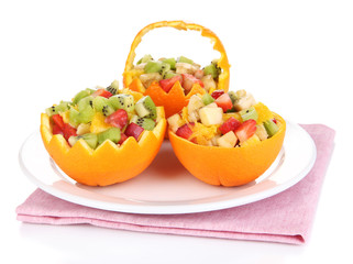 Fruit salad in hollowed-out orange isolated on white
