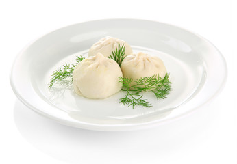 Tasty khinkali on plate, isolated on white