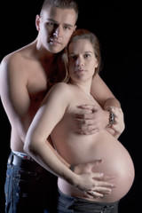 Pregnant woman posing with her husband