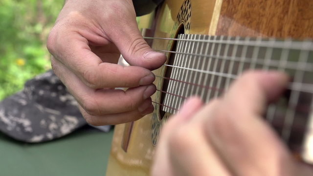 Playing the Guitar. Slow Motion at a rate of 480 fps