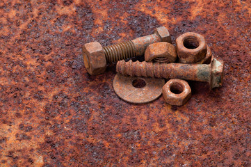 Rusty nuts and bolts on rusty metal