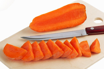 Cutting the carrots and a knife on a cutting board