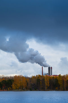 Air pollution by smoke coming out of factory chimneys.