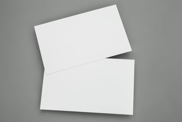 blank business cards on grey background