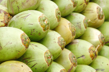 Closeup of the stacked green coconuts