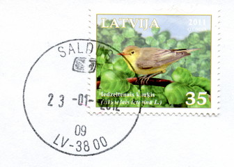 Canceled latvian stamp "Icterine warbler"