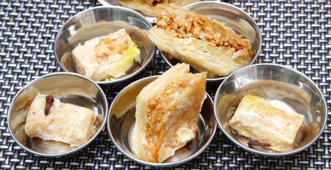 Arabic sweets kept in steel bowls