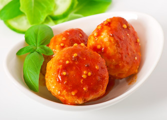 meatballs in tomato sauce, decorated with leaves of basil