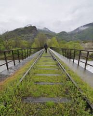 Fototapeta na wymiar hiker on an abandoned railway