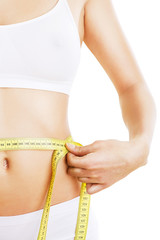 close-up photo of sporty woman body with tapemeasure