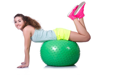 Young woman with ball exercising on white