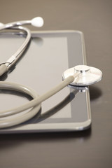 Doctor workplace with digital tablet and stethoscope
